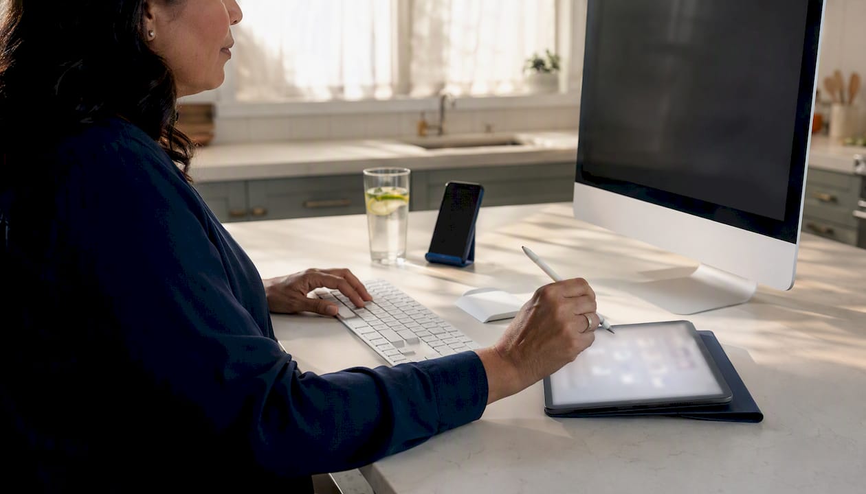 Hands typing with AI call flow on tablet