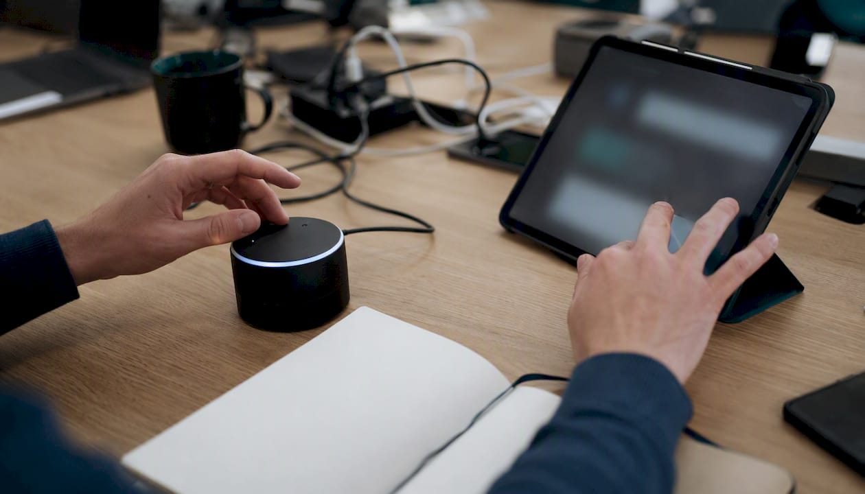 Hands interacting with voice assistant devices during testing