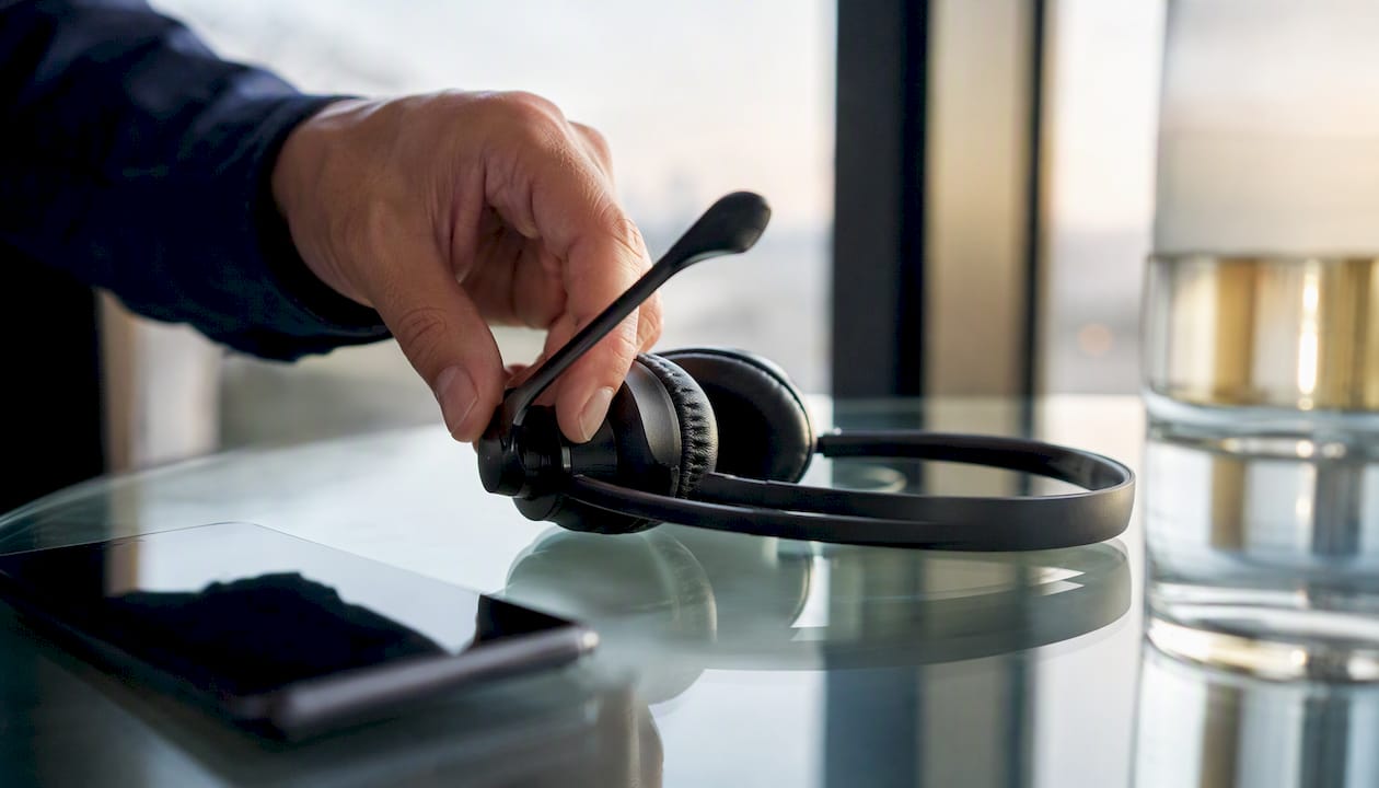 Hand adjusting headset microphone boom