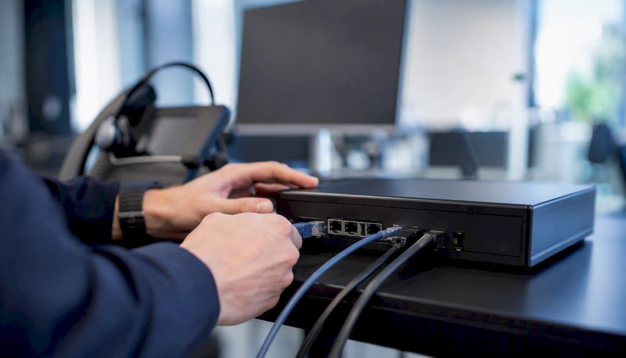 Hands connecting telephony adapter cables
