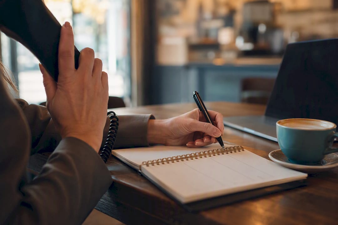 Hands on phone booking appointment at desk